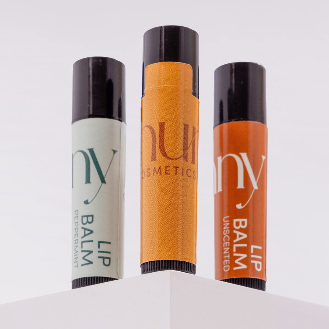 Three lip balm tubes from Hunny Cosmetics on a white background.