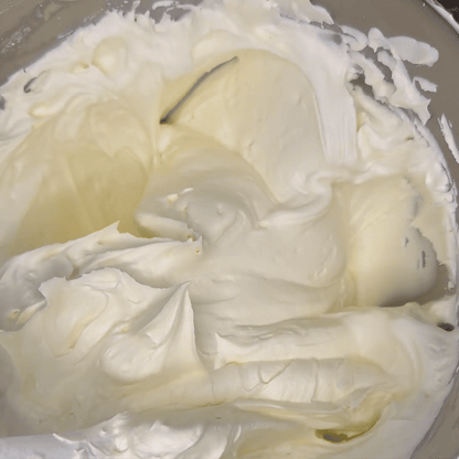 Tallow being stirred in a mixing bowl showing a fluffy, whipped texture.